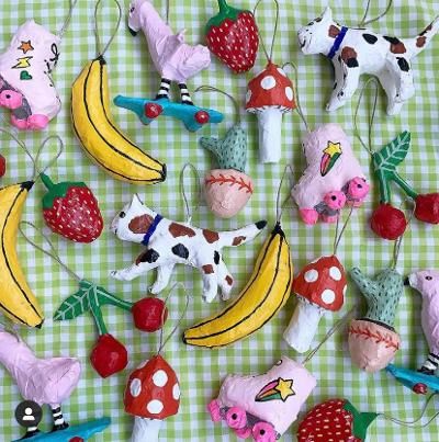 various toy animals and fruits are on a checkered tablecloth