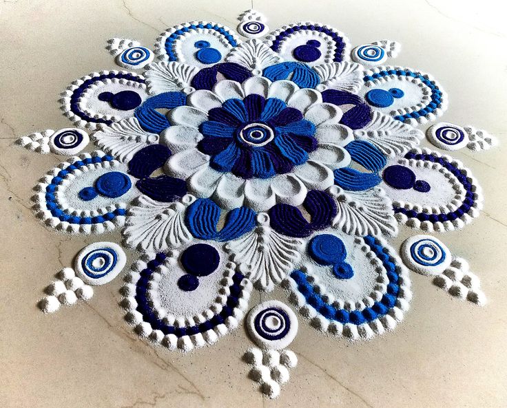 a blue and white circular design on a marble surface with circles in the shape of an ornament