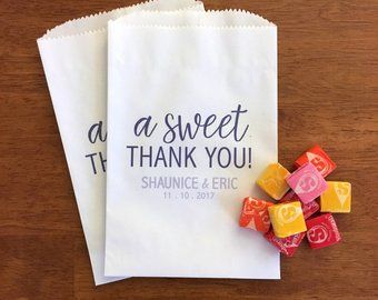 two bags with candy on them sitting next to each other and the words asweet thank you