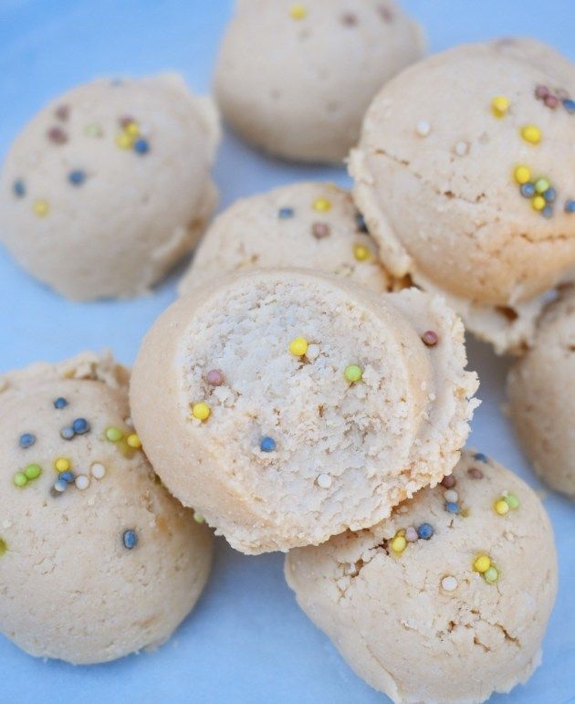 several cookies with sprinkles on a blue plate