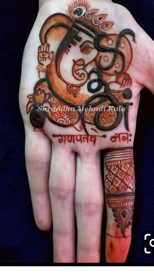 a person's hand with an intricate tattoo on it