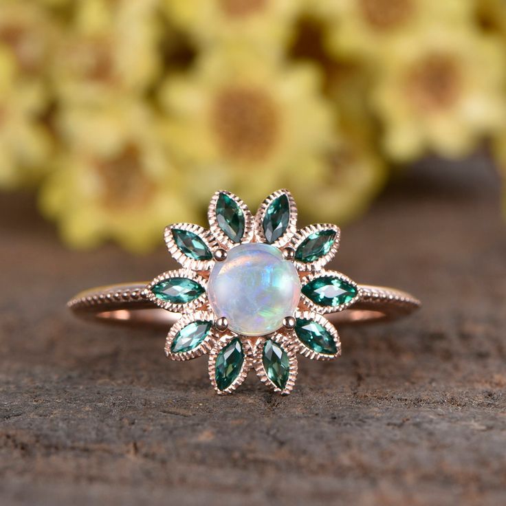 Natural Opal emerald ring, marquise emerald leaf flower halo design, unique milgrain wedding band rose gold ITEM DESCRIPTION Opal engagement ring ✦Solid 14k white/ rose/yellow gold ✦Approx Band width approx 1.5mm(bottom) ✦5mm Round cut 0.5ctw VS natural Opal ✦1.5x3mm Marquise cut lab emeralds ✦Prong Set Jewelry maintenance tips ▶ To avoid of chemical reactions,do not touch with daily chemicals,such as soap,shower gel,shampoo,chemicals. ▶ To avoid deformation or breakage on any collision or stres Elegant May Birthstone Flower Ring With Gemstone, Fine Jewelry With Marquise Cut May Birthstone, Fine Jewelry Round Flower Ring With May Birthstone, Fine Jewelry Flower Ring With May Birthstone Gemstone, Fine Jewelry May Birthstone Flower Ring, Emerald Jewelry With Marquise Cut Center Stone, Opal Anniversary Ring Fine Jewelry, Fine Jewelry Opal Ring For Anniversary, May Birthstone, Wedding Jewelry With May Birthstone, Round Shape