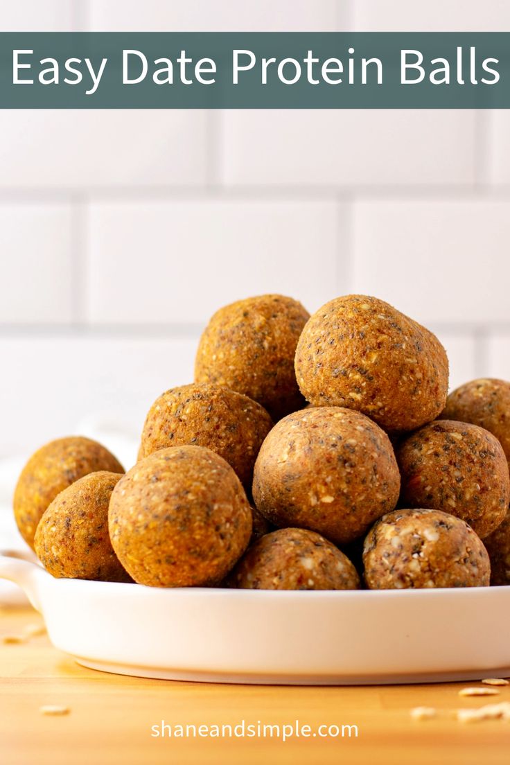 a white bowl filled with raw protein balls on top of a wooden table and text overlay that reads easy date protein balls