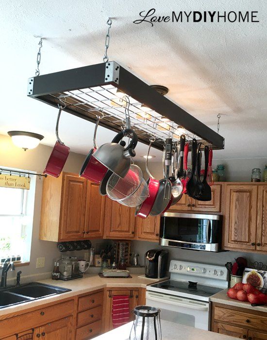 pots and pans hanging from the ceiling in a kitchen