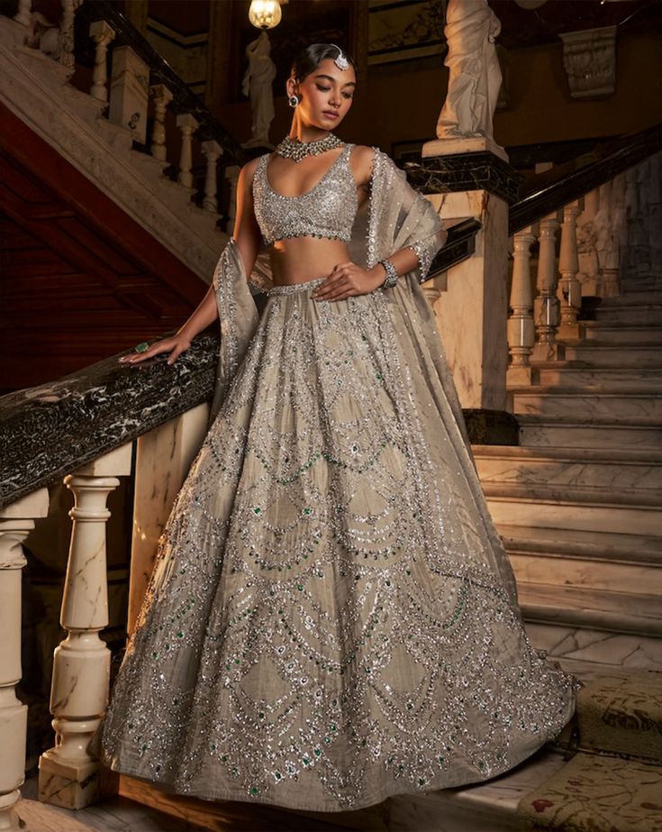 This lehenga set features emerald and crystal embroidery in chandelier inspired pattern on a champagne tissue silk base. The matching blouse has emerald drops at the waist .The tissue organza dupatta has a matching embroidery.From Seema Gujral's Falaknuma collection. DELIVERY TIMEPlease allow 8-12 weeks for your outfit to arrive. FABRIC DETAILSLehenga & Blouse - Tissue SilkDupatta - Tissue organza Professional cleaning only. Seema Gujral, Lehenga Bridesmaid, Matching Embroidery, Crystal Embroidery, Indian Lehenga, Organza Dupatta, 12 Weeks, Professional Cleaning, Embroidered Blouse