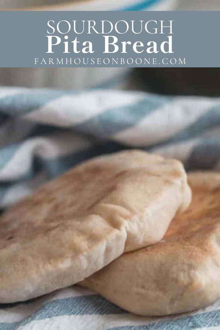 two uncooked pita breads sitting on top of a blue and white towel