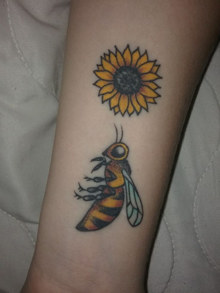 a tattoo with a bee and a sunflower on it