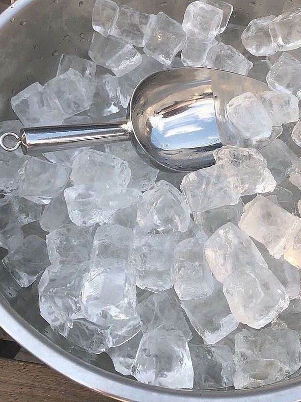 ice cubes in a bucket with a spoon