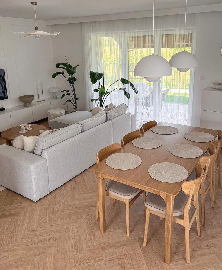 a living room and dining area with wood flooring