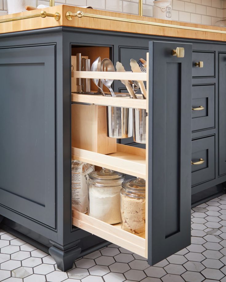 an open cabinet in the middle of a kitchen