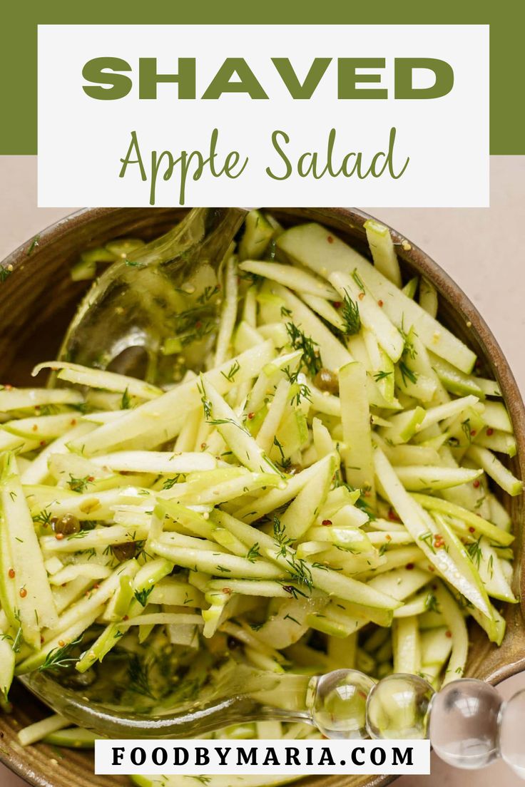 shaved apple salad in a wooden bowl with spoons on the side and text overlay