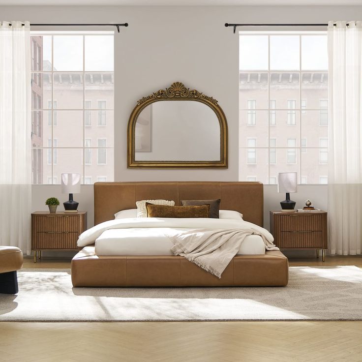 a bedroom with a bed, dressers and mirror in it's center area