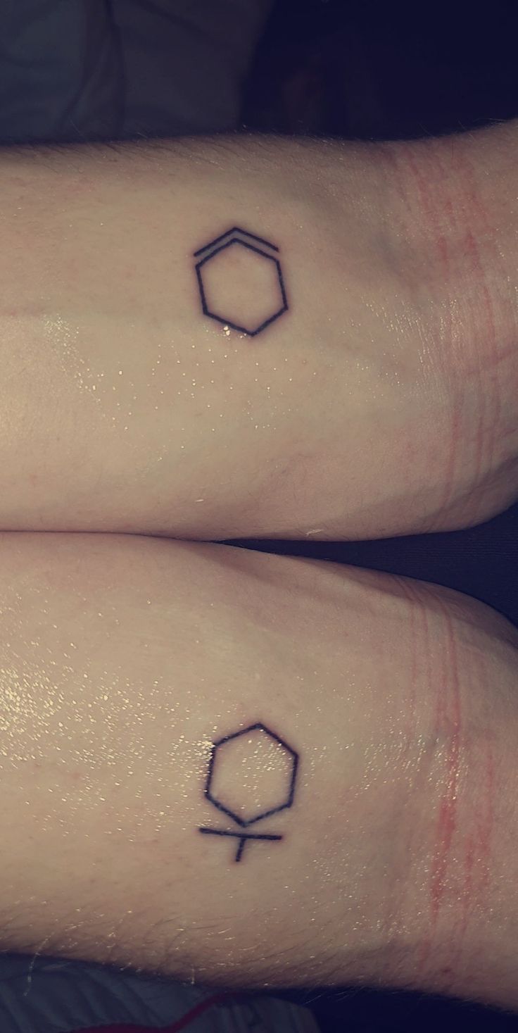 two small tattoos on both arms that have geometric shapes and lines painted on the sides