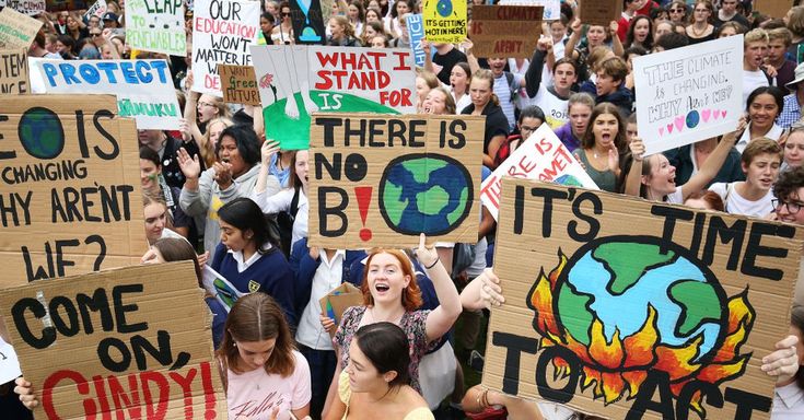 a large group of people holding up signs