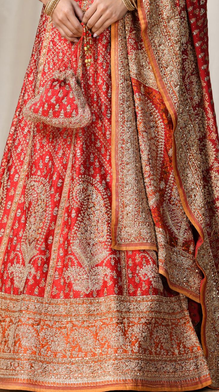 Editor's Note This set features a red & saffron paisley lehenga with blouse and dupatta. Neck: V-Neck Sleeve Type: Cap Sleeves Fabric: Silk Satin Care: Dry Clean Only About the Designer Ri Ritu Kumar is one of India’s foremost designers. She has developed a unique style of her own, reflecting the ancient traditions of Indian craftsmanship in a contemporary vocabulary. With a background in art history and museology, which has enriched her horizons, Ritu’s understanding of ancient designs and the Red Bollywood Anarkali Set With Traditional Drape, Red Raw Silk Anarkali Set For Navratri, Festive Red Cutdana Sets, Red Anarkali Set With Intricate Embroidery, Designer Red Set With Dupatta, Anarkali Chandbali Red Sets, Anarkali Red Sharara With Pallu, Red Cutdana Set For Diwali, Red Anarkali Designer Wear Set