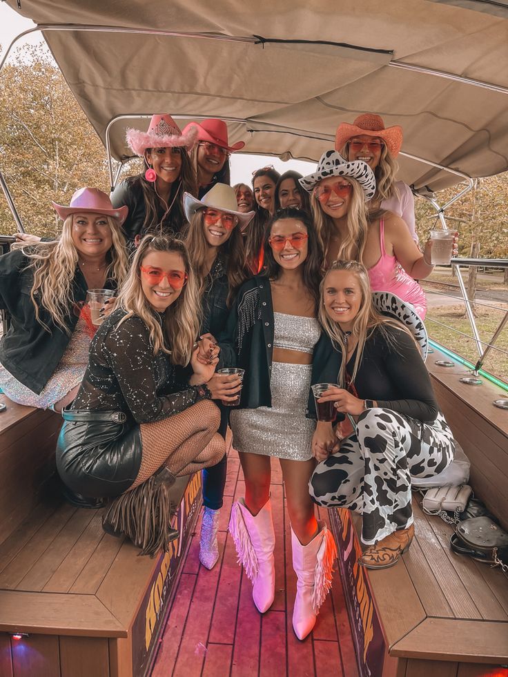 a group of people on a boat posing for a photo with one woman in the foreground