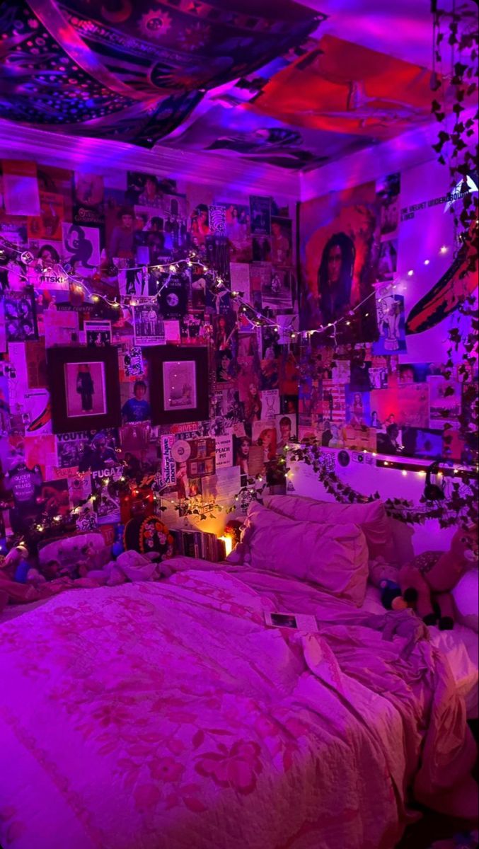 a bedroom with purple lights and pictures on the wall above the bed, along with other decorations