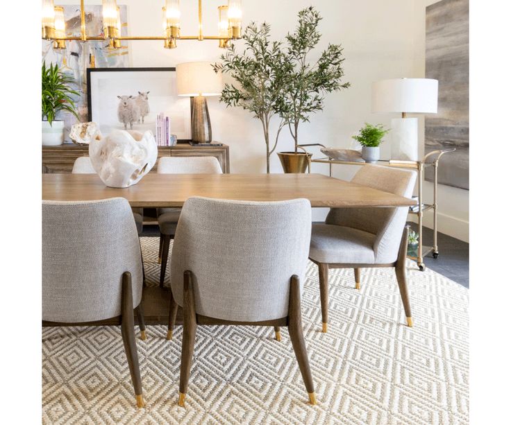 a dining room table surrounded by chairs and lamps