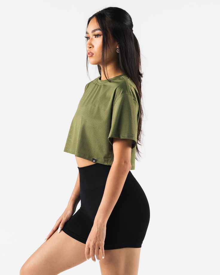 HIGHLIGHTS. Short sleeve Breathable mesh Layering FIT SUGGESTION. This item runs true to Alphalete's oversized fit... Laura is 5’6”/168cm, wearing a size XS. with 28"/71cm bust. MATERIALS AND WASHING DIRECTIONS. 65% Nylon, 35% Spandex. We recommend washing inside-out on a cold setting. Hang to dry DESCRIPTION This light weight mesh makes for the perfect summer layering piece. Wear it over any of your favorite Alphalete bras for a stylish layer that will help keep you cool in the summer heat. | A Mesh Layering, Summer Layering, Layered Fits, Crop T Shirt, Summer Heat, Crop Tshirt, Crop Tee, Layering Pieces, Perfect Summer