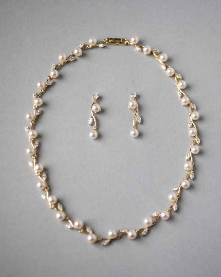 a necklace and earring set with pearls