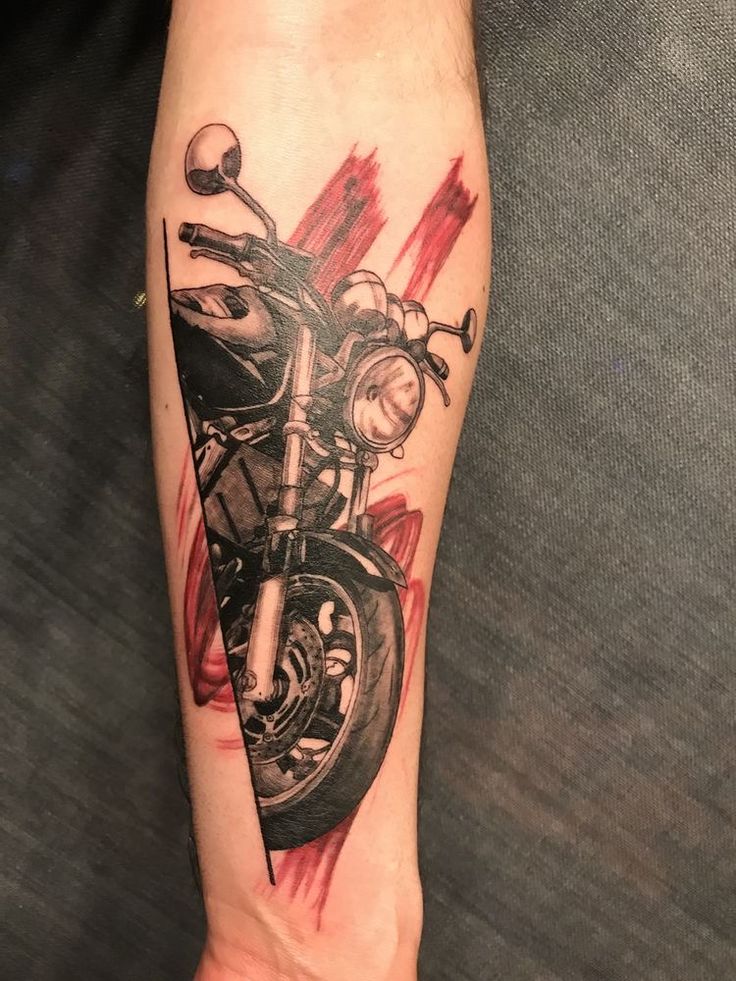 a tattoo on the arm of a person with a motorcycle