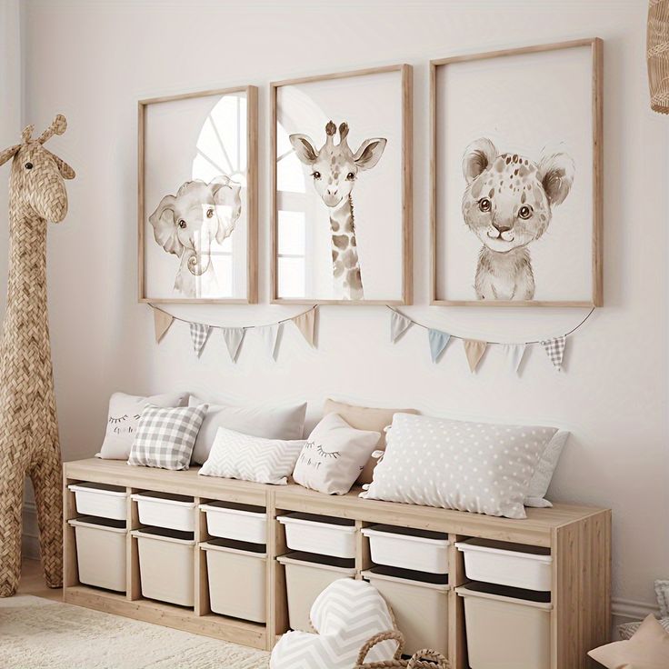 a room with three pictures on the wall and two giraffes hanging above