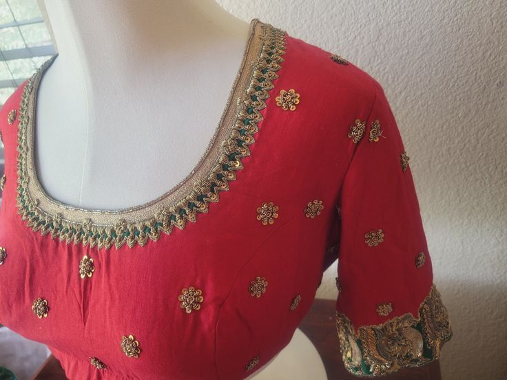 "Vermilion red Saree blouse in the softest Maheshwari silk cotton fabric and luxurious embroidery.   Gorgeous combination of bright red and bottle green with exclusive golden hand embroidery, antique flat sequins and pitta zardosi, antique badla work royal silver and golden peacocks on the sleeves, elegant neckline, floral booties that sparkle and make this an apt choice for any special occasion, be it is for a festival, wedding, or any party.  Pot neck style with high neck, back hooks, royal elegance  Size: 40\"  (Size can be downsized or upsized for additional alteration charge) Very elegant and much more gorgeous in person than in pictures!" Festive Chinon Blouse With Intricate Embroidery, Red Saree Blouse With Zari Work, Festive Green Chinon Blouse, Festive Transitional Chinon Blouse, Designer Red Blouse With Cutdana, Festive Chinon Blouse With Pallu, Traditional Green Chinon Blouse, Red Dola Silk Blouse With Zari Work, Red Chanderi Blouse Piece With Intricate Embroidery