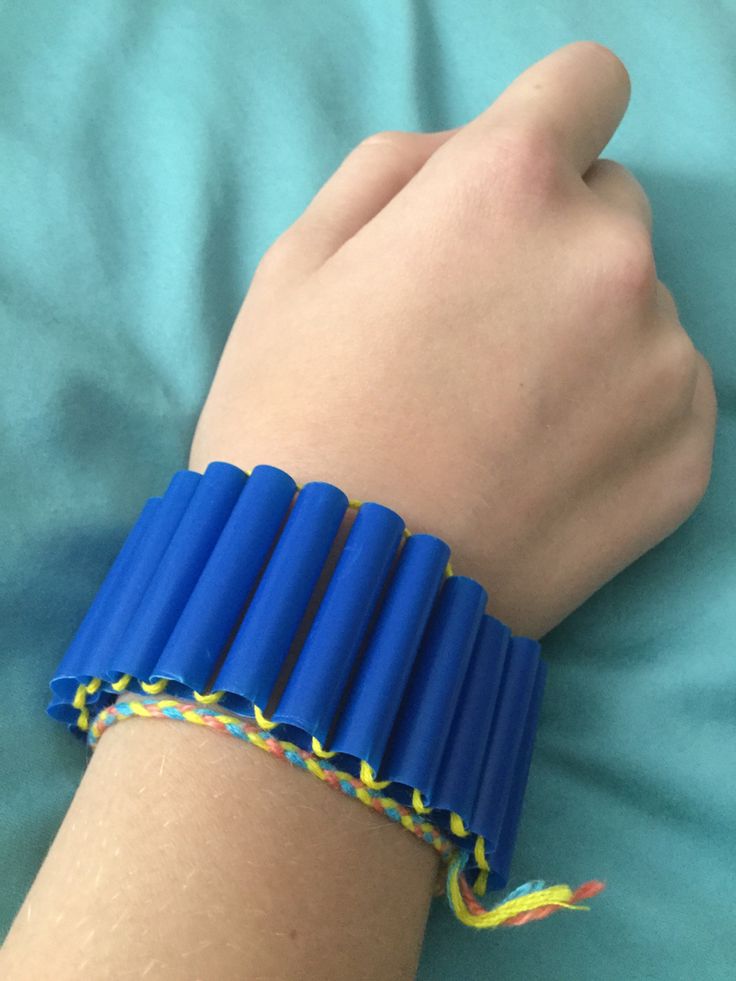 a person wearing a bracelet made out of blue plastic tubes