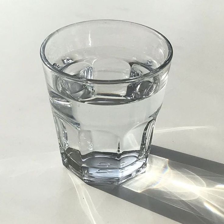 a clear glass filled with water sitting on top of a table