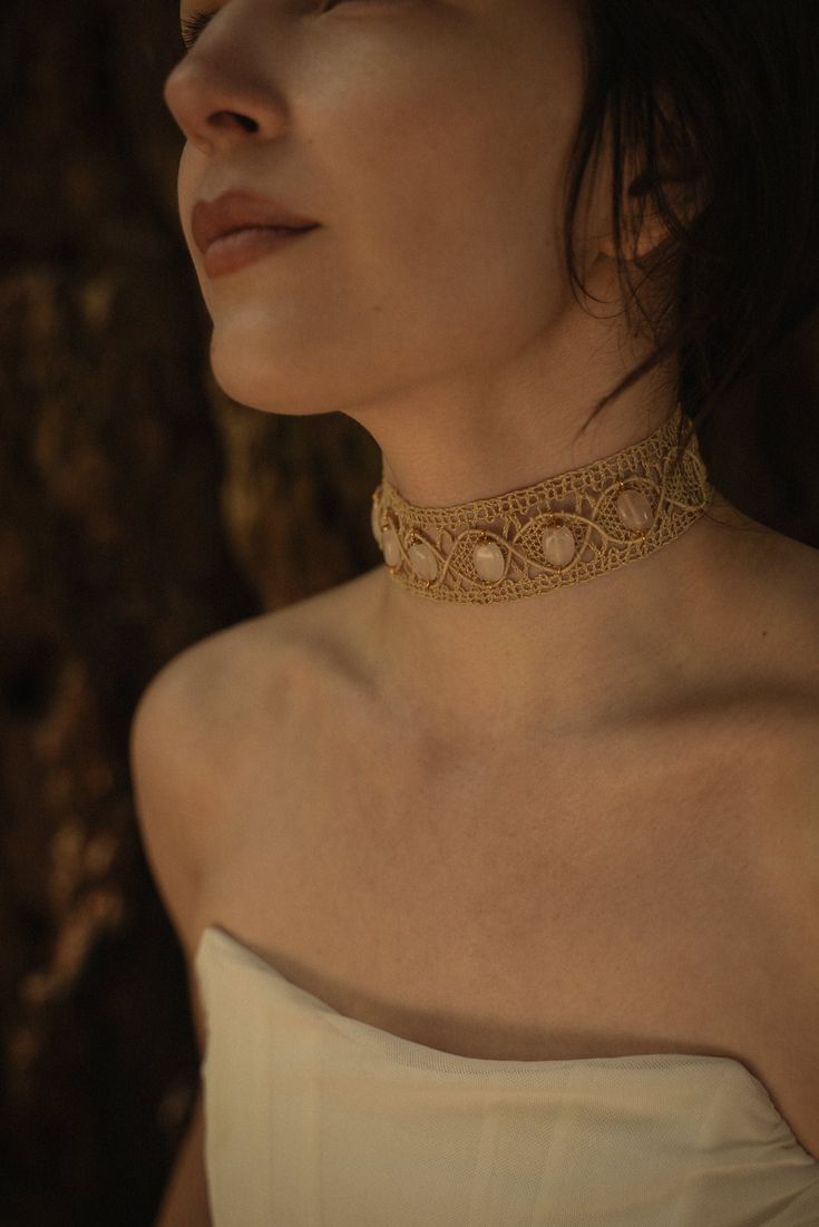 This handmade choker is a unique 1.5" wide and 10" in length. The woven lace is of the highest quality, as are the metals, all 24k gold plated brass and raw brass. On this choker are 6 half inch rose quartz beads, attached with careful craftsmanship. Rose Quartz is a gorgeous rose-colored stone carrying powerful energies of: love, compassion, harmony (balance), and emotional healing.  The clasp makes wearing this choker easy, and the plates are able to bend to follow the curve of your neck if you wish to do so.  The style of this choker is one that could easily pair with an evening gown, and just as easily compliment a sweater and jeans. How will you style it? Tag us so we can see! @messageinstone Any questions? Comments? Need help? Message! Happy to chat anytime. Gold Macrame Choker For Festivals, Gold Macrame Choker Necklace, Unique Gold Beaded Choker, Adjustable Macrame Choker, Gold Macrame Brass Necklaces, Gold Brass Macrame Necklace, Gold Artisan Handmade Choker, Handmade Artisan Gold Choker, Handmade Gold Artisan Choker