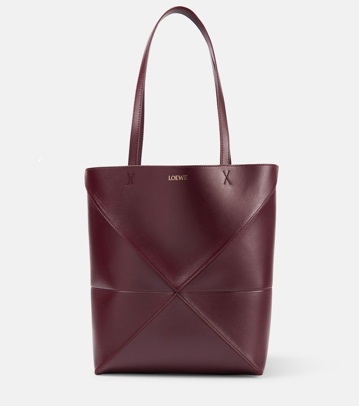 Designer Leather Tote Bucket Bag, Designer Leather Bucket Bag Tote, Luxury Leather Tote Bucket Bag, Designer Burgundy Leather Bags, Luxury Bags With Leather Backing And Double Handle, Luxury Satchel With Leather Backing And Double Handle, Luxury Leather-backed Double Handle Satchel, Designer Tote Bag With Leather Backing, Designer Leather-backed Tote Bag