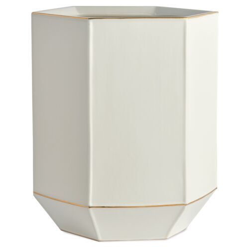 a white vase with gold trim on the bottom