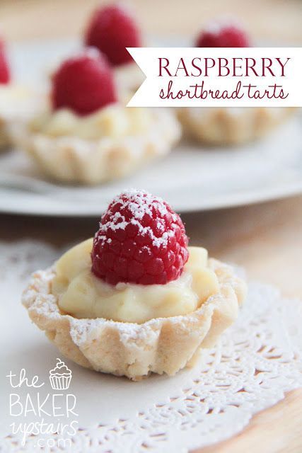 raspberry shortbread tarts with powdered sugar on top