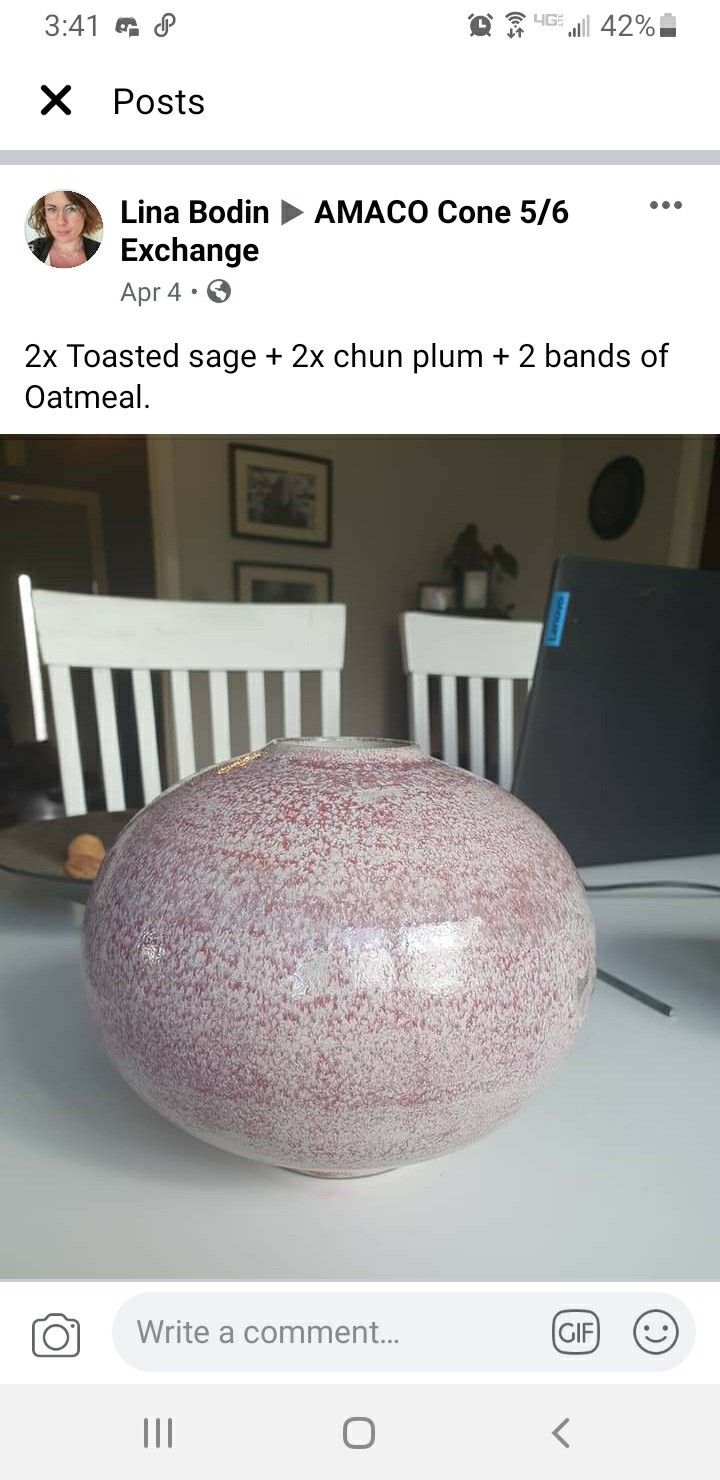 a pink and white vase sitting on top of a table