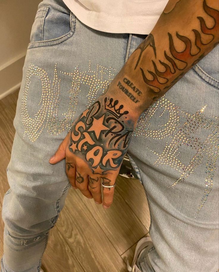 a man with tattoos on his arm and hand