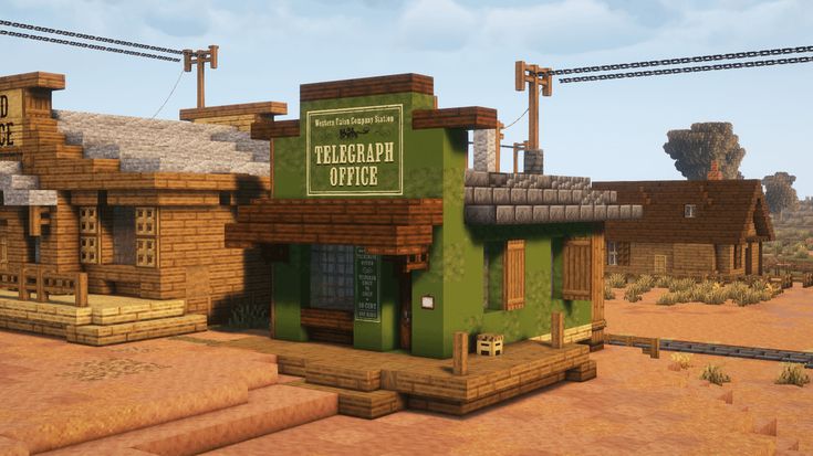 a small green building sitting in the middle of a desert area with power lines above it