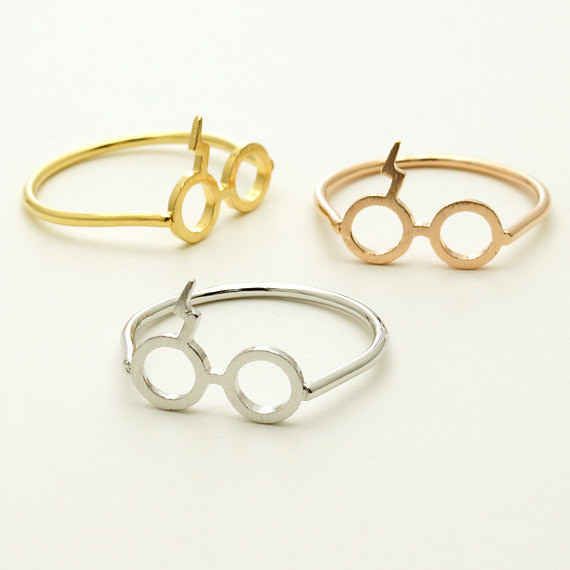 three harry potter rings are shown on a white surface, one is gold and the other is silver