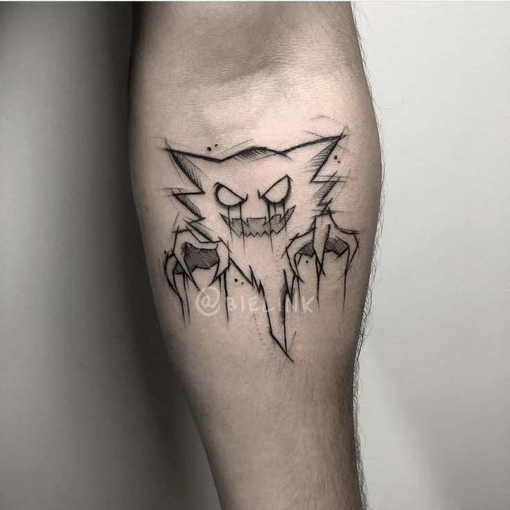 a man's leg with an evil cat tattoo on it