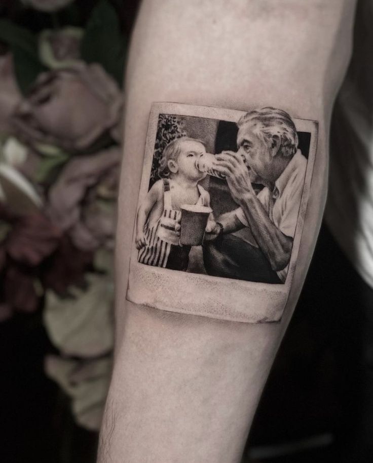 a man with a small photo tattoo on his arm