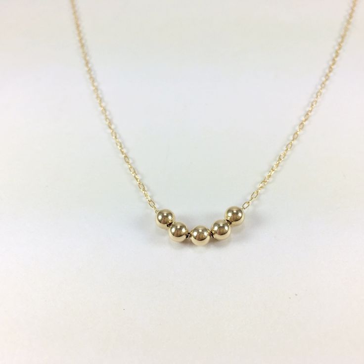 IF YOU LIVE OUTSIDE THE US AND WOULD LIKE TO ORDER FROM MY SHOP, PLEASE MESSAGE ME FOR DETAILS. Dainty Gold Bead Necklace, 14K Gold Fill Ball Necklace, Sterling Silver Bead Necklace, Small Gold Beads Necklace, Delicate Chain Necklace, Layering Necklace Minimal in design this dainty necklace consists of your choice of 4mm Beads on a delicate 14k Gold filled or Sterling Silver chain. Bead Choices are: Shiny 14k Gold Filled or Sterling Silver Star Dust 14k Gold or Sterling Silver Corrugated (Groove Ball Chain Necklace With Round Beads For Gifts, Gift Chain Necklace With Polished Round Beads, Minimalist Gold Beaded Necklaces With Tiny Beads, Gift Chain Necklace With Polished Beads, Gold Necklace With Tiny Beads In 14k Gold Filled, Gold Necklaces With Polished Beads For Everyday, Everyday Gold Necklaces With Polished Beads, Everyday Gold Necklace With Polished Beads, Gold Beaded Necklaces With Spacer Beads For Gift