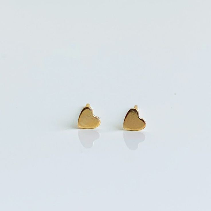 The sweetest little heart shaped stud earrings for every day. 14k yellow gold 3.5mm flat heart Minimalist Gold Heart Earrings With Charm, Gold Minimalist Heart Earrings For Everyday, Minimalist Everyday Heart Earrings, Tarnish Resistant, Minimalist Gold Hypoallergenic Heart Earrings, Yellow Gold Double Heart Earrings For Everyday, Minimalist Hypoallergenic Heart Earrings For Valentine's Day, Minimalist Tarnish-resistant Heart Earrings As Gift, Hypoallergenic Minimalist Heart Earrings For Valentine's Day, Everyday Double Heart Tarnish-resistant Earrings