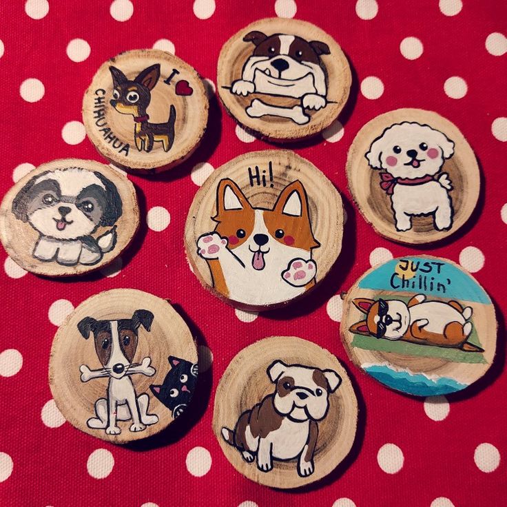 six wooden magnets with dogs on them sitting on a polka dot tablecloth covered surface