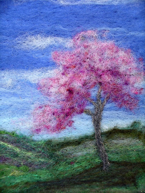 a drawing of a pink tree in the middle of a green field with blue sky and clouds