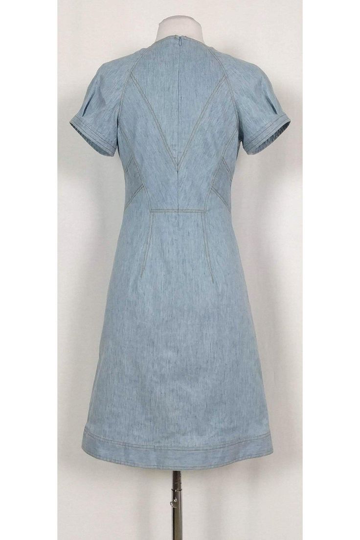 Versatile denim dress featuring a classic semi flared silhouette. The perfect dress to wear to a picnic at the park, pair it with chic sandals and a statement handbag. Size 4 Lined, cotton & elastane blend V-neckline Short sleeves Unlined Flared silhouette Mustard top stitching Above knee Bust 34" Waist 28" Shoulder to hem 37" Medium Wash Cotton A-line Denim Dress, Classic Medium Wash Denim Dress For Spring, Fitted Midi-length Denim Dress For Spring, Fitted Midi Denim Dress For Spring, Fitted A-line Denim Blue Dress, Classic Denim Dress For Workwear In Spring, Elegant Short Sleeve Denim Summer Dress, Classic Spring Denim Dress For Work, Summer A-line Cotton Denim Dress