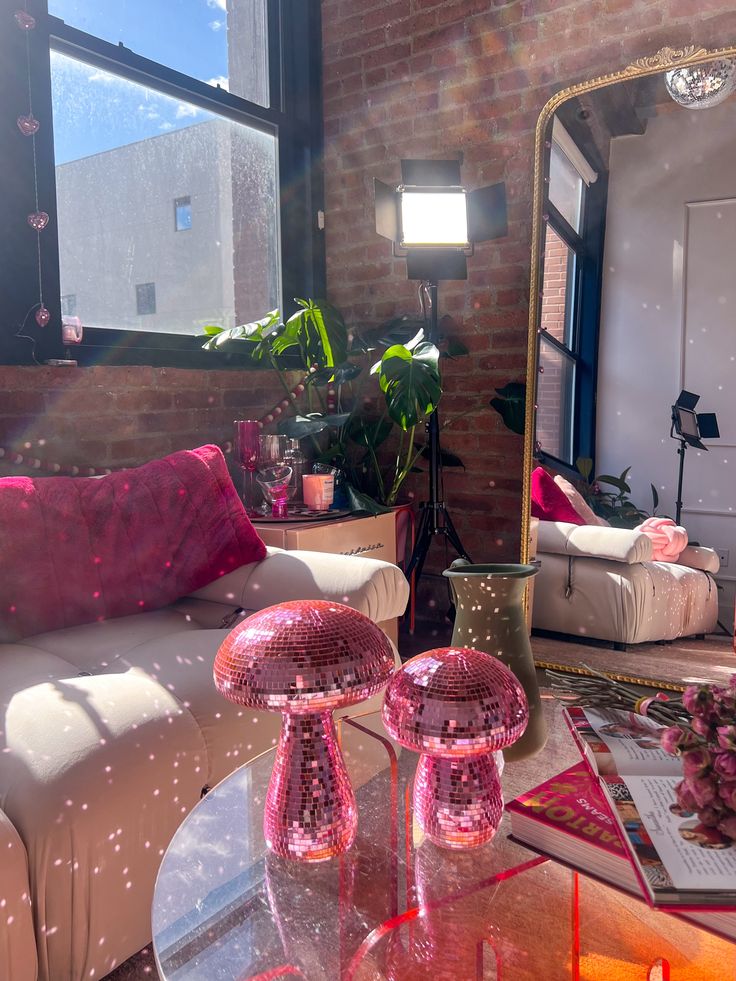 a living room filled with furniture and a large mirror on top of a coffee table