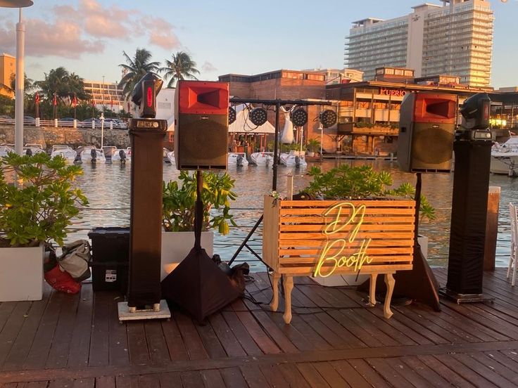 some speakers are sitting on a wooden dock