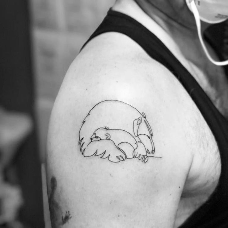 a black and white photo of a man's arm with a tattoo on it