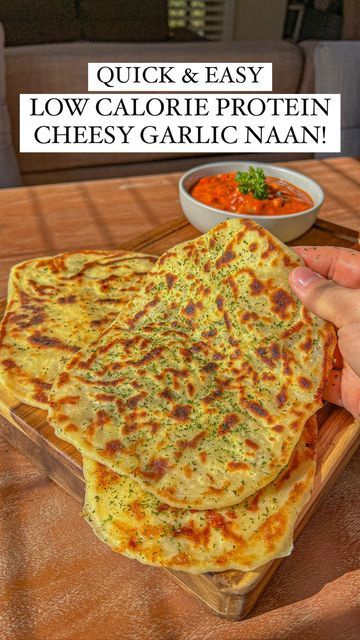 a person holding a plate with food on it and the words quick & easy low calorie protein cheesy garlic naan