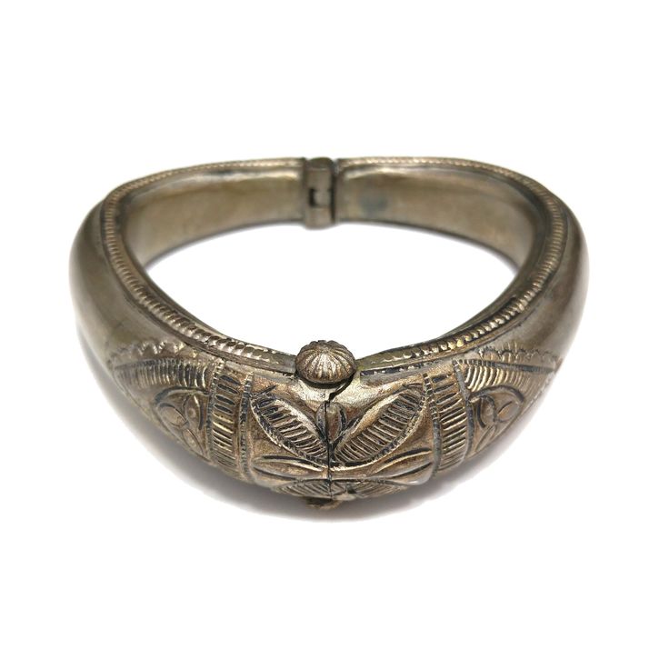 *Description: This is a great embossed design tribal bracelet with a hinge and plunger clasp which makes it very easy to take on and off from the 1940s. The plunger stays attached so you don't have to worry about loosing it. The bracelet has a gold wash, which I tested at 10K gold surface metal. The bracelet under the gold wash is a non-magnetic brass metal; probably mostly hollow. The shape of the bracelet is very unique and is more of a triangular shape with the flat portion on the bottom behi Vintage Hinged Bangle, Antique Hinged Cuff Bracelet Bangle, Antique Hinged Cuff Bracelet, Antique Hinged Bangle Cuff Bracelet, Vintage Hinged Bracelet Jewelry, Vintage Hinged Bangle Bracelet, Vintage Hinged Bracelet, Vintage Ceremonial Metal Jewelry, Vintage Bronze Cuff Bracelet With Intricate Design