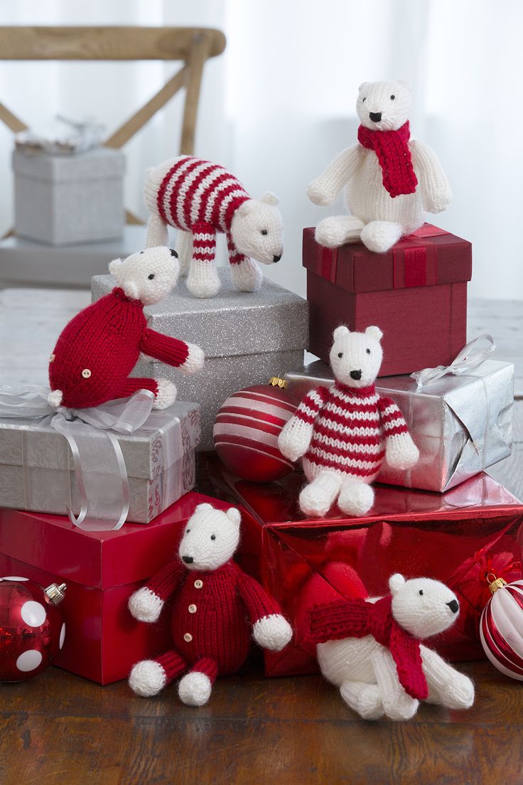 teddy bears are sitting on presents in red and white